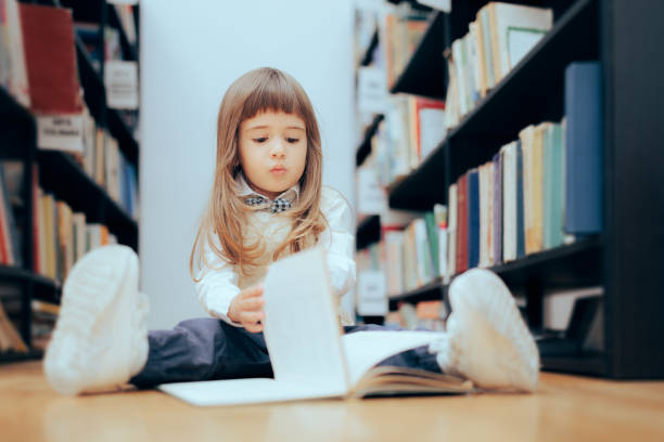istock Smart Little Girl Checking a Book at the Library 1397642121