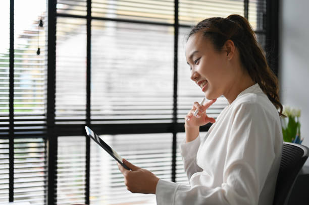 istock Female boss sits in the office checking her assistant's work on the digital tablet 1397642162