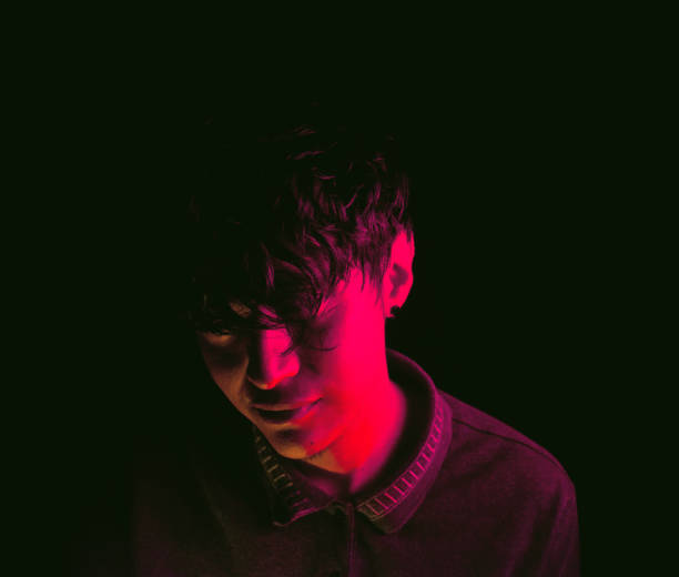 istock Mysterious young man in neon lights 1397642279