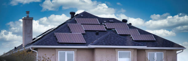 istock A house with several solar panels on the roof with a blue sky and clouds. 1397645418