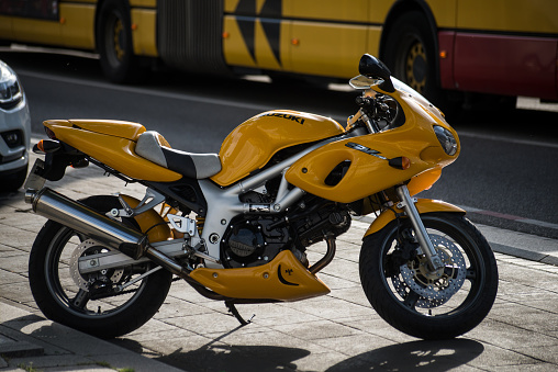 Mulhouse - France - 16 May 2022 - Profile view of yellow Suzuki SV 650 motorbike parked in the street