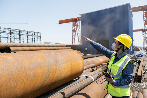 A female engineer uses a hardness tester to test steel in a chemical plant in Fujian,China.