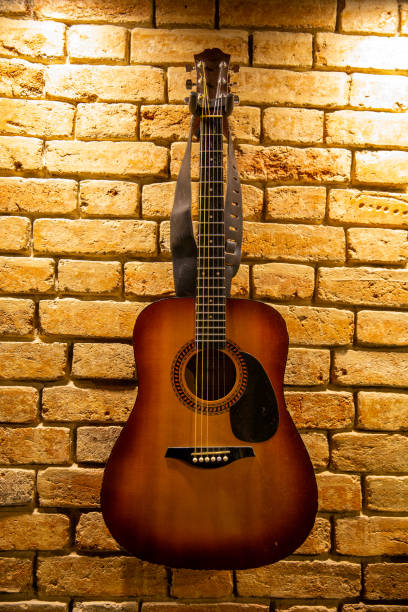 istock Acoustic guitar on brick wall background 1397646962