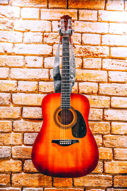 istock Acoustic guitar on brick wall background 1397647970
