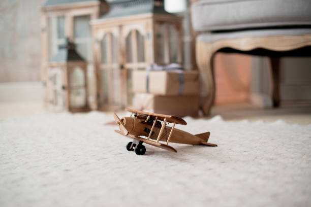 A toy airplane is lying on the floor in the room A toy airplane is lying on the floor in the room toy airplane stock pictures, royalty-free photos & images