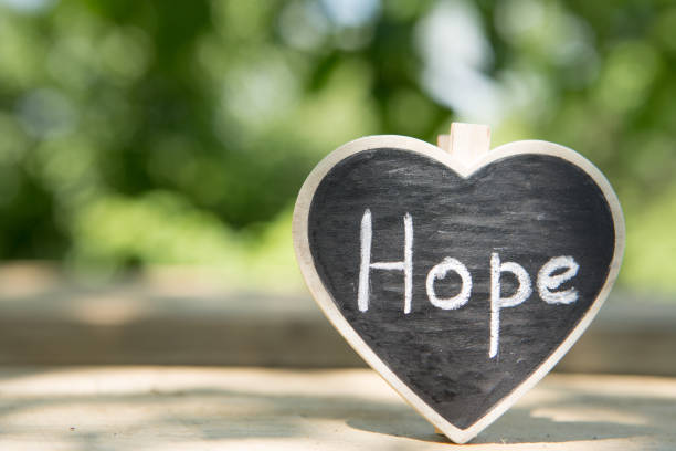 istock Hope - inscription on the heart, sharing hope concept, green bokeh background 1397656706