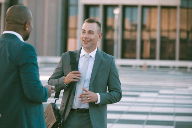 Successful businessmen having a conversation outside their office