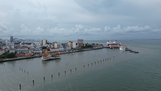 Georgetown, Penang Malaysia - May 14, 2022: The Swettenham Cruise Ship Terminal and the coastal area around it. Shots are from the sea looking into the city of the Penang island, with some vessels visible in sight around the Swettenham Pier