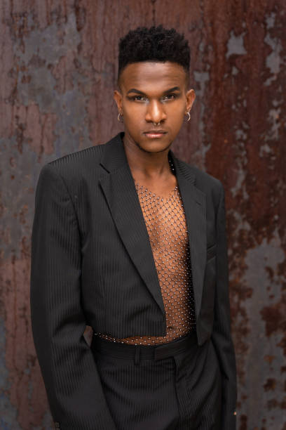 istock Black ethnic man in a fashionable pose on a metallic background 1397661187