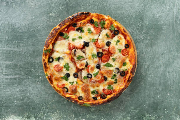 istock Delicious vegetarian tomato and cheese pizza with greens 1397663356