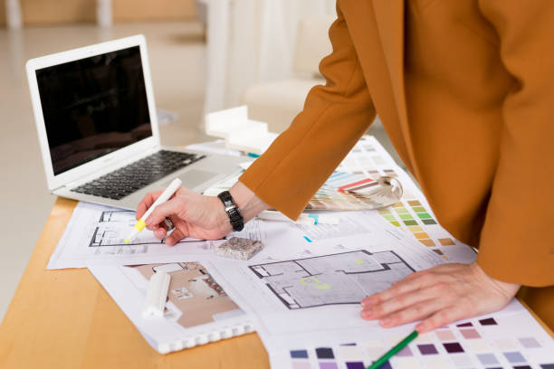 istock Woman architect working on interior renovation in workplace. Designer choosing color samples according to the visualization and blueprints of the project. Architecture and interior design concept. 1397665764