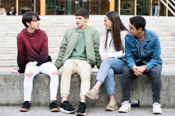 istock Group of teenagers talking sitting on a bench 1397666431