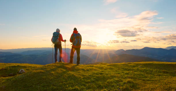 istock Couple standing on top of mountain 1397666796