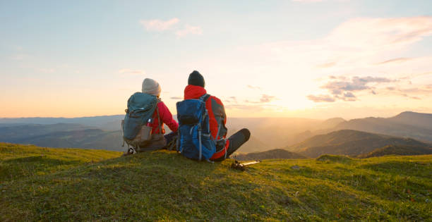 istock Couple sitting on top of mountain 1397666798