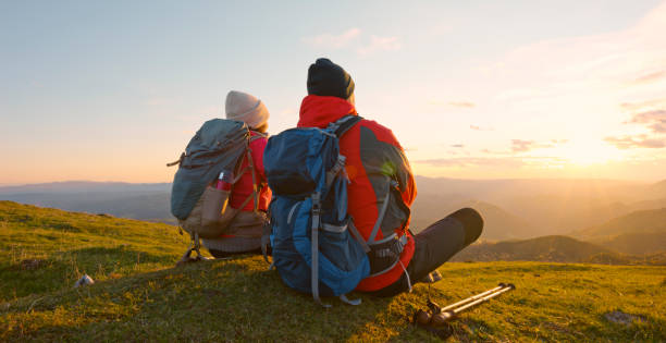 istock Couple sitting on top of mountain 1397666802