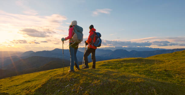 istock Couple standing on top of mountain 1397666811