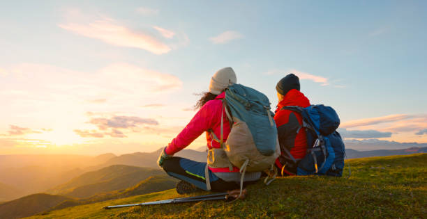 istock Couple sitting on top of mountain 1397667456