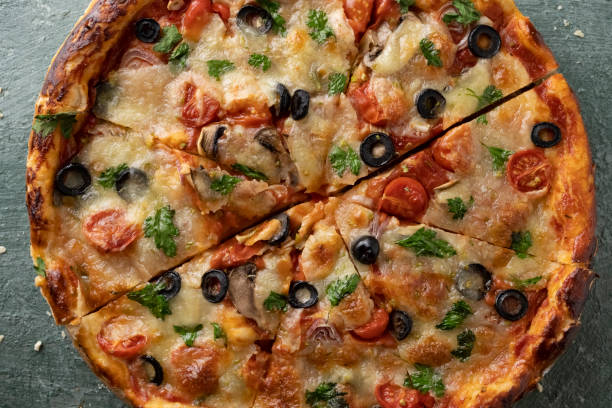 istock Delicious vegetarian tomato and cheese pizza with greens 1397667870