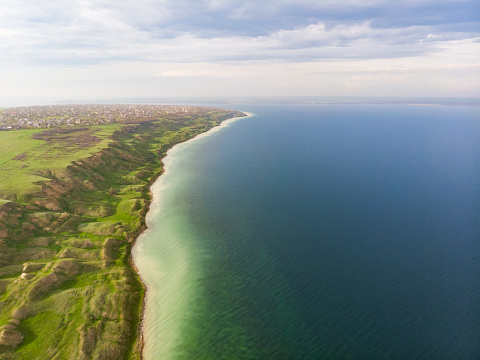 Aerial view of surreal coastline with unreal terrain hills near calm green water sea estuary, Adzhalyk, Ukraine
