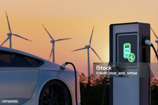 Environmentally Friendly Electric Car Charging On Background Of Wind Turbines Evening Sunset View Of Ev Station With Port Plugged In Car Realistic 3d Rendering Of Alternative Energy Concept Stock Photo - Download Image Now