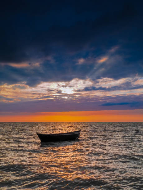 istock Empty fishing boat in the rays of the setting sun. 1397669443
