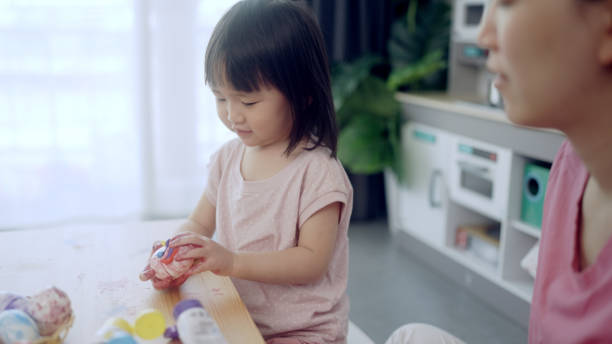 istock Mother and his daughter are painting eggs 1397670087