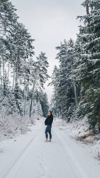 istock Young woman relaxes on snow-covered trail 1397670643