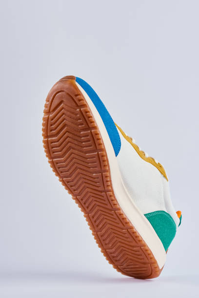 istock Trendy colorful shoes sole on gray background 1397671485