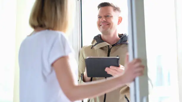 Photo of Smiling man conducting social survey in apartment