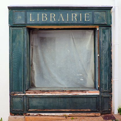 facade of an old abandoned bookstore in the town of Audierne, in the Finistère department in the south of beautiful Brittany.