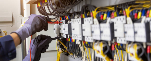 istock Electrician engineer tests electrical installations and wires on relay protection system. Adjustment of scheme of automation and control of electrical equipment. 1397675694