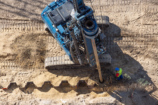 aerial view of drilling rig for sheet piling on construction site