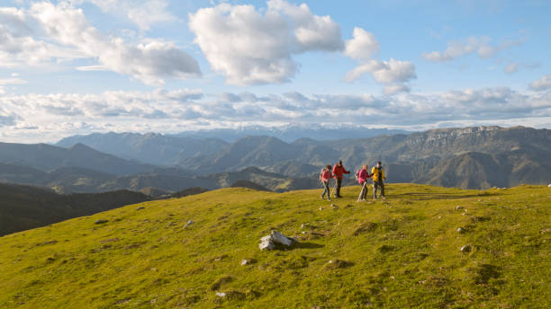 istock Friends hiking on mountain top 1397678692