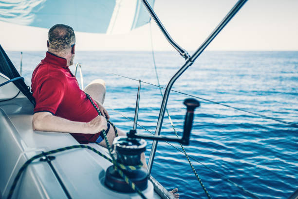 istock Sailing crew member trimming gennaker sail on sailboat 1397678795