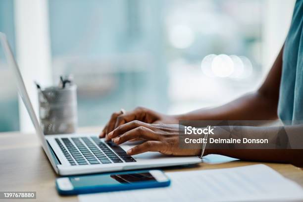 Closeup Of A Black Businesswoman Typing On A Laptop Keyboard In An Office Alone Stock Photo - Download Image Now