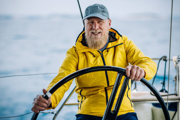 Skipper sailing on sailboat stock photo