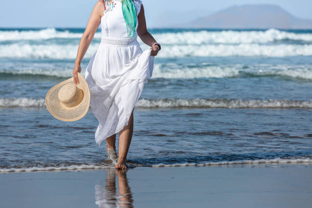 istock Crop woman walking in sea waves 1397680120