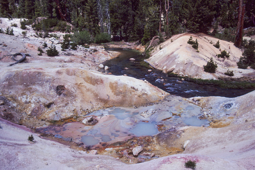 Hot springs along Warner Creek in Devil's Kitchen, Lassen Volcanic National Park, California, USA. Spring water made milky by precipitation of amorphous silica as hot spring water cools. 1982 Kodachrome scanned film.