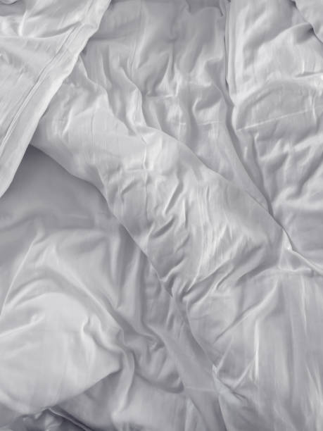 istock Messy white bed duvet cover 1397681328