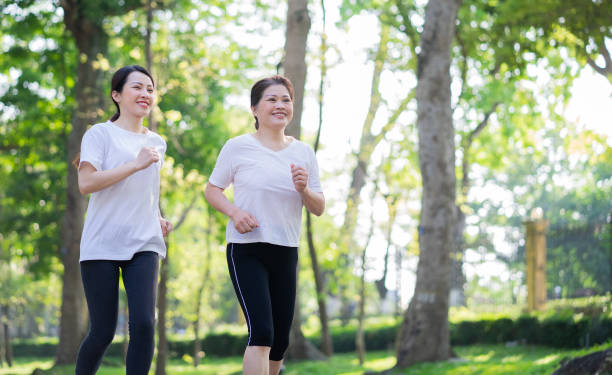 istock Image of Asian mother and daughter exercise at park 1397681630