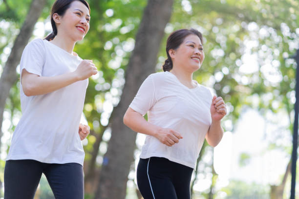 istock Image of Asian mother and daughter exercise at park 1397681675