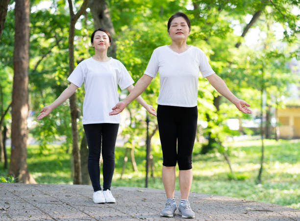 istock Image of Asian mother and daughter exercise at park 1397681682