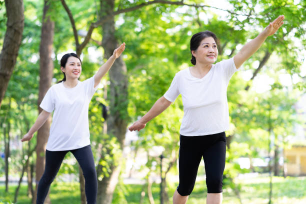 Image of Asian mother and daughter exercise at park