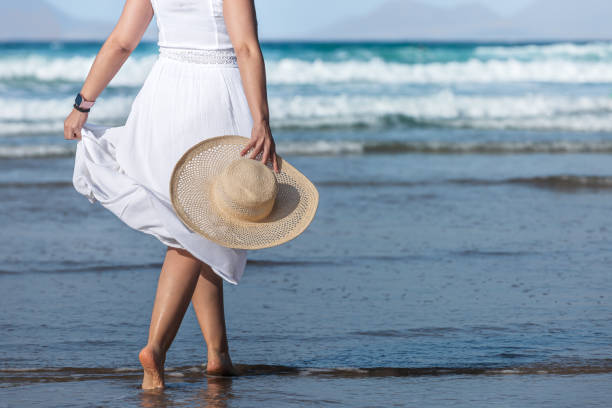 istock Crop barefoot female walking in sea water 1397681851