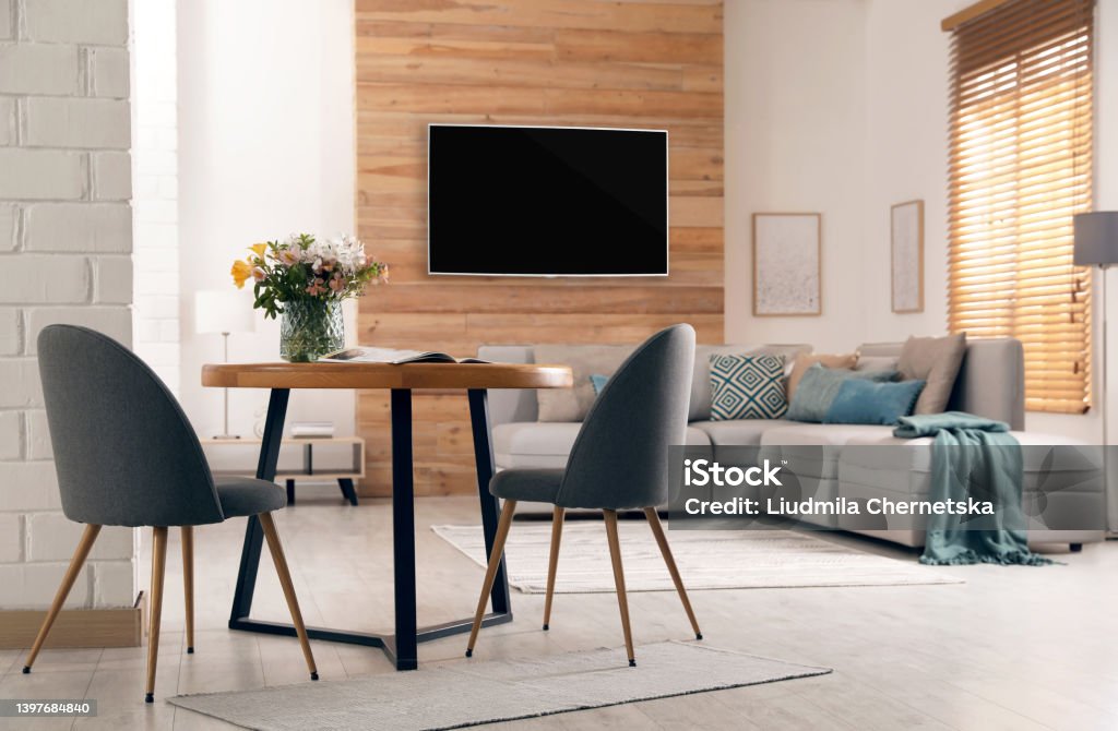 Modern wide screen TV on wall in room with stylish furniture Furniture Stock Photo