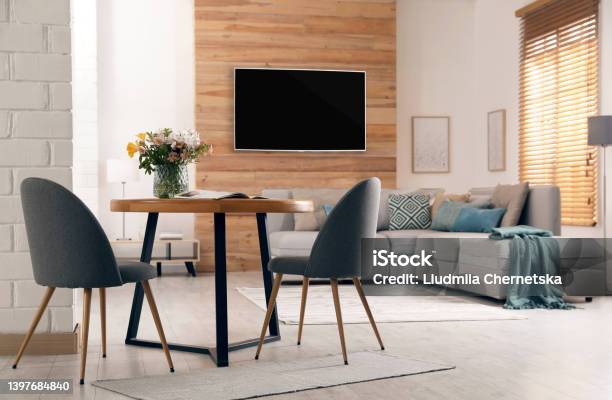Modern Wide Screen Tv On Wall In Room With Stylish Furniture Stock Photo - Download Image Now