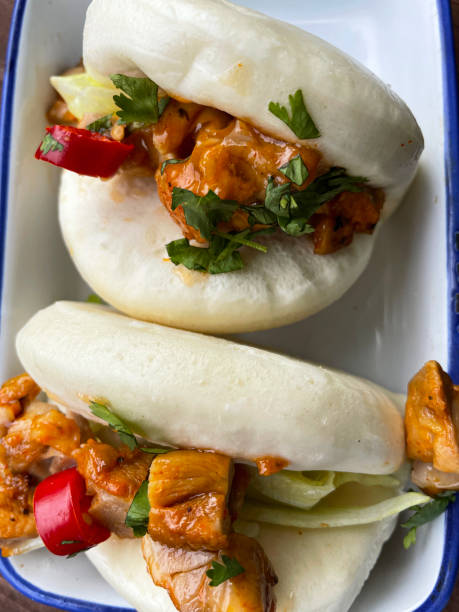 istock Full frame image of white serving dish of sweet chilli chicken Bao buns, elevated view 1397684946