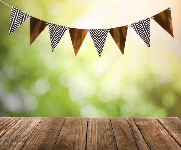 istock Empty wooden table and decorative bunting flags outdoors 1397685065