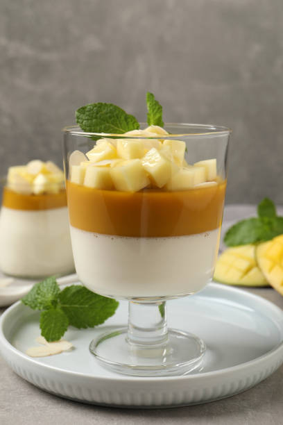 istock Delicious panna cotta with mango on grey table 1397685109