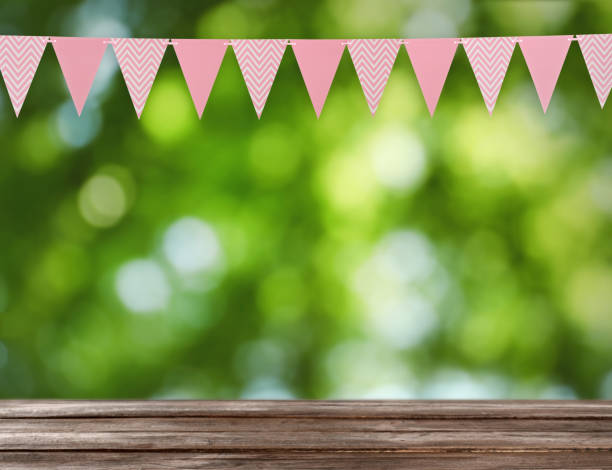 istock Empty wooden table and decorative bunting flags outdoors 1397685125